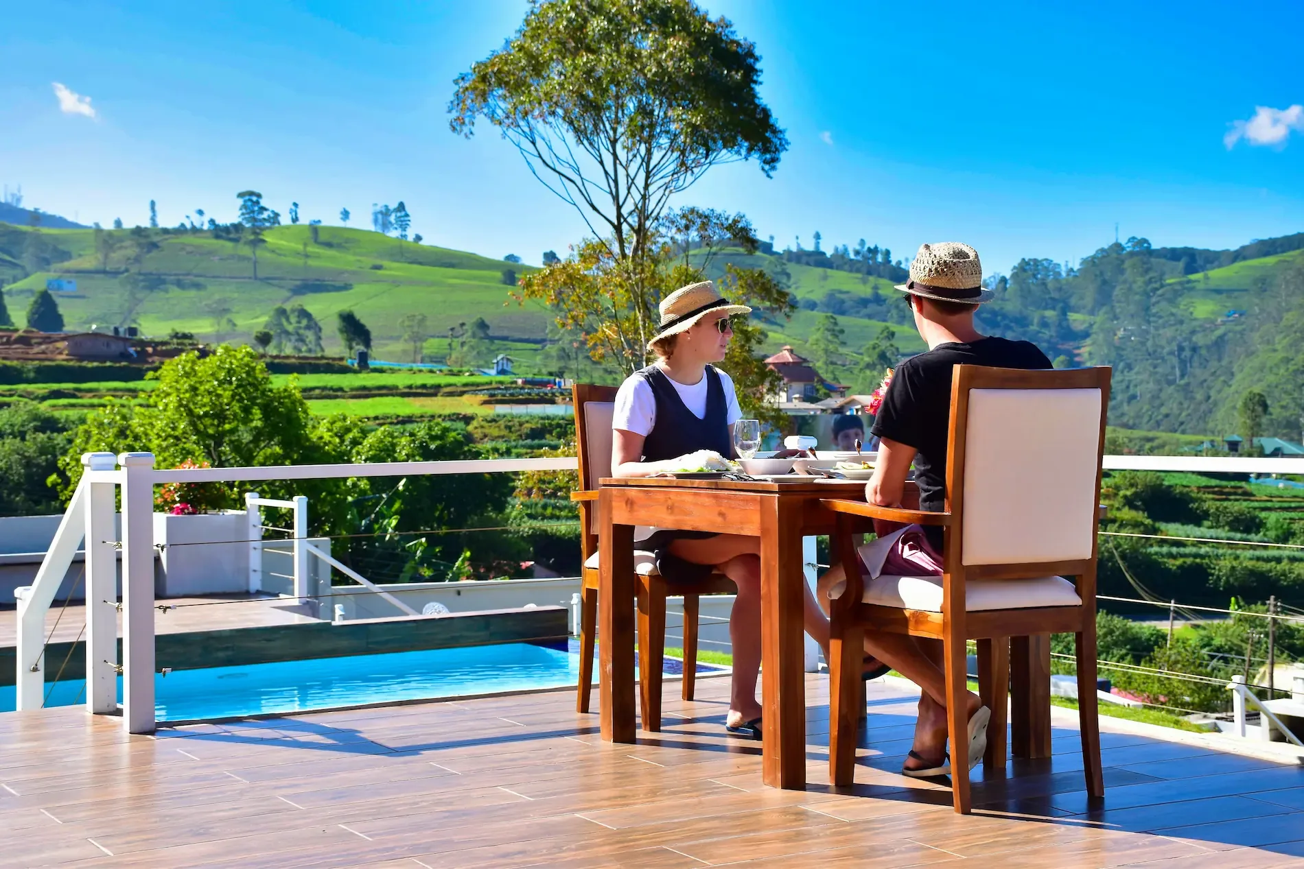 Couple dining beside the Temperature Controlled infinity pool at Hilldale Retreat romantic boutique hotel in Nuwara Eliya Sri Lanka